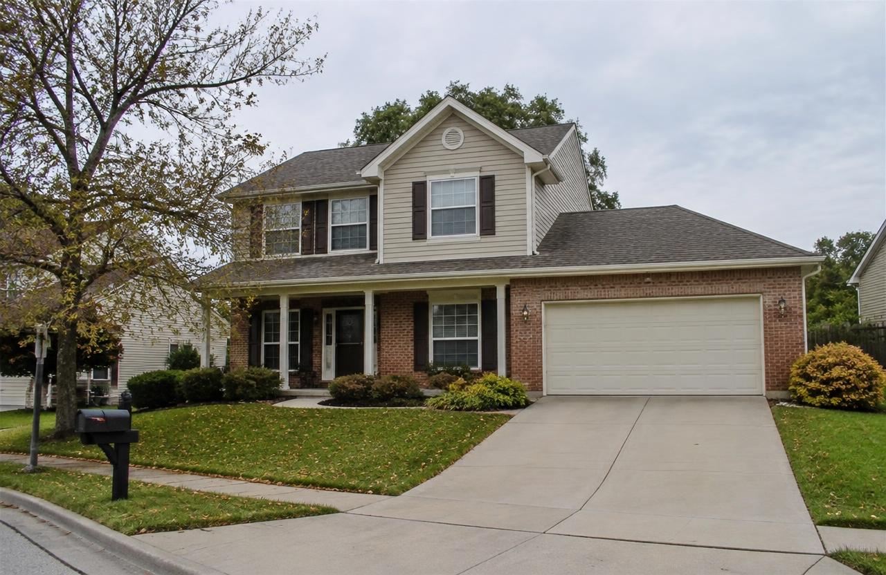 Suburban two-story home with a garage needing light updates — AI-generated property illustration, not a verified local property